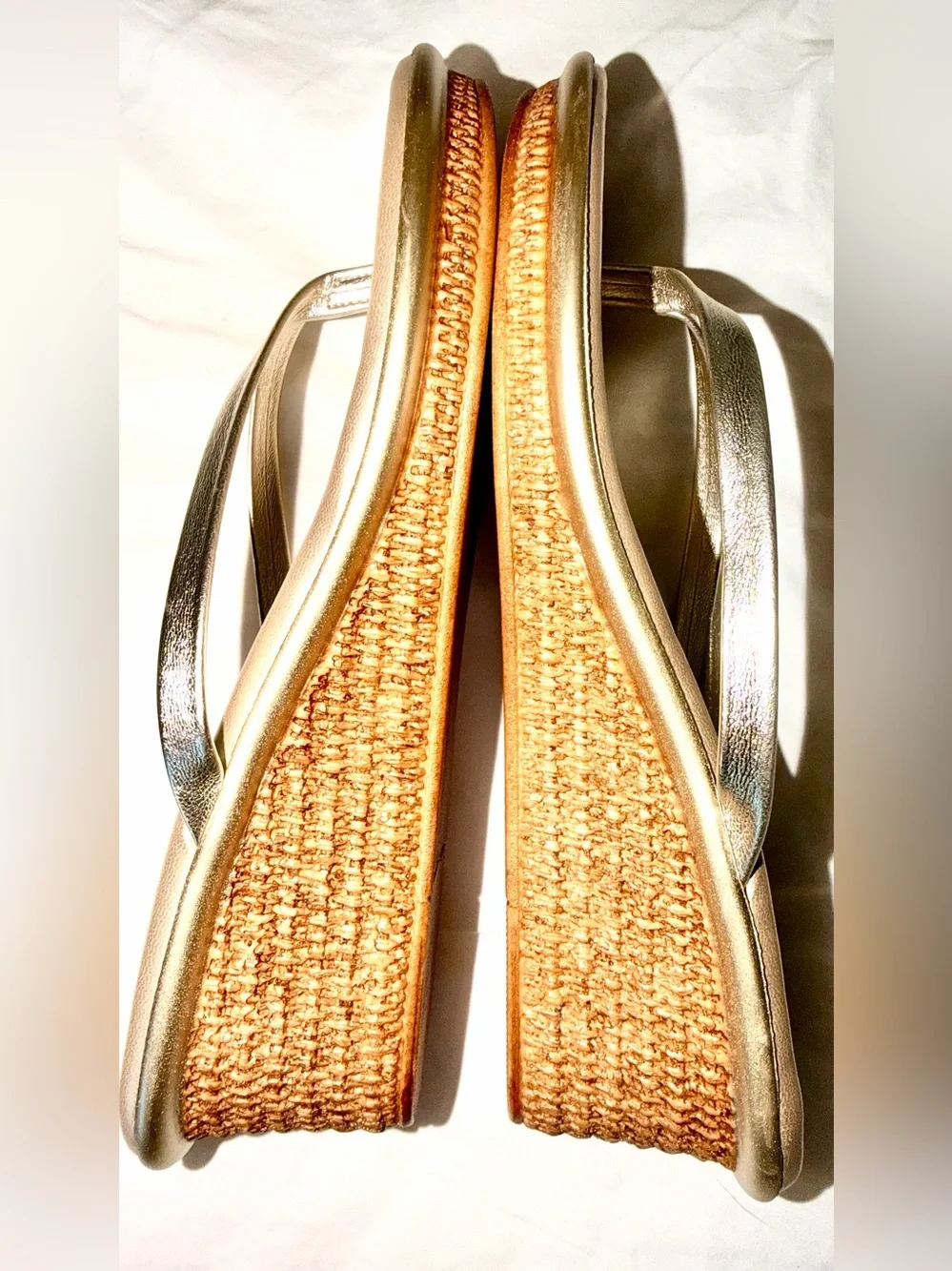 Italian Shoemakers thong wedge sandals feature a metallic gold finish